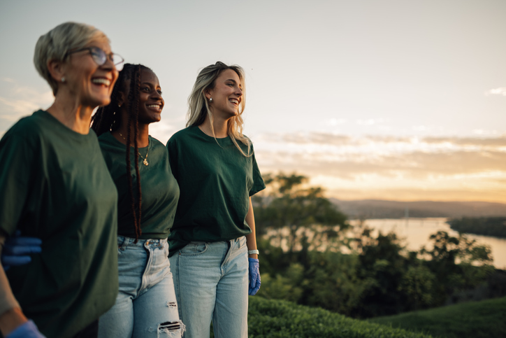 Volunteers walking and admiring the sunset over the river iStock