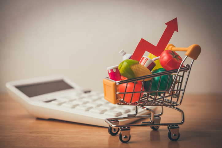 Red arrow growth chart, food, drinks, vegetables, fruits in supermarket trolley. iStock