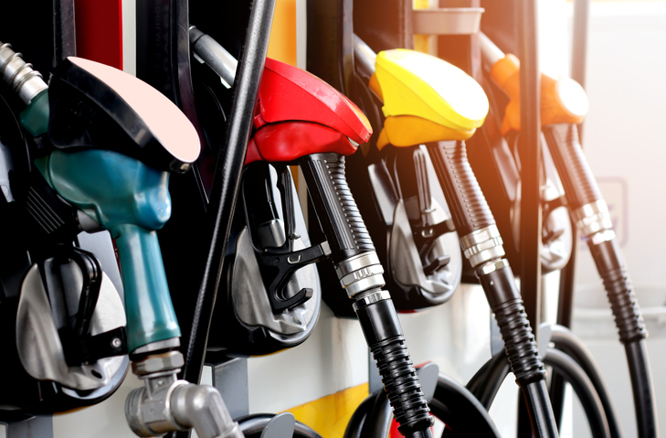 red green yellow orange color fuel gasoline dispenser background iStock